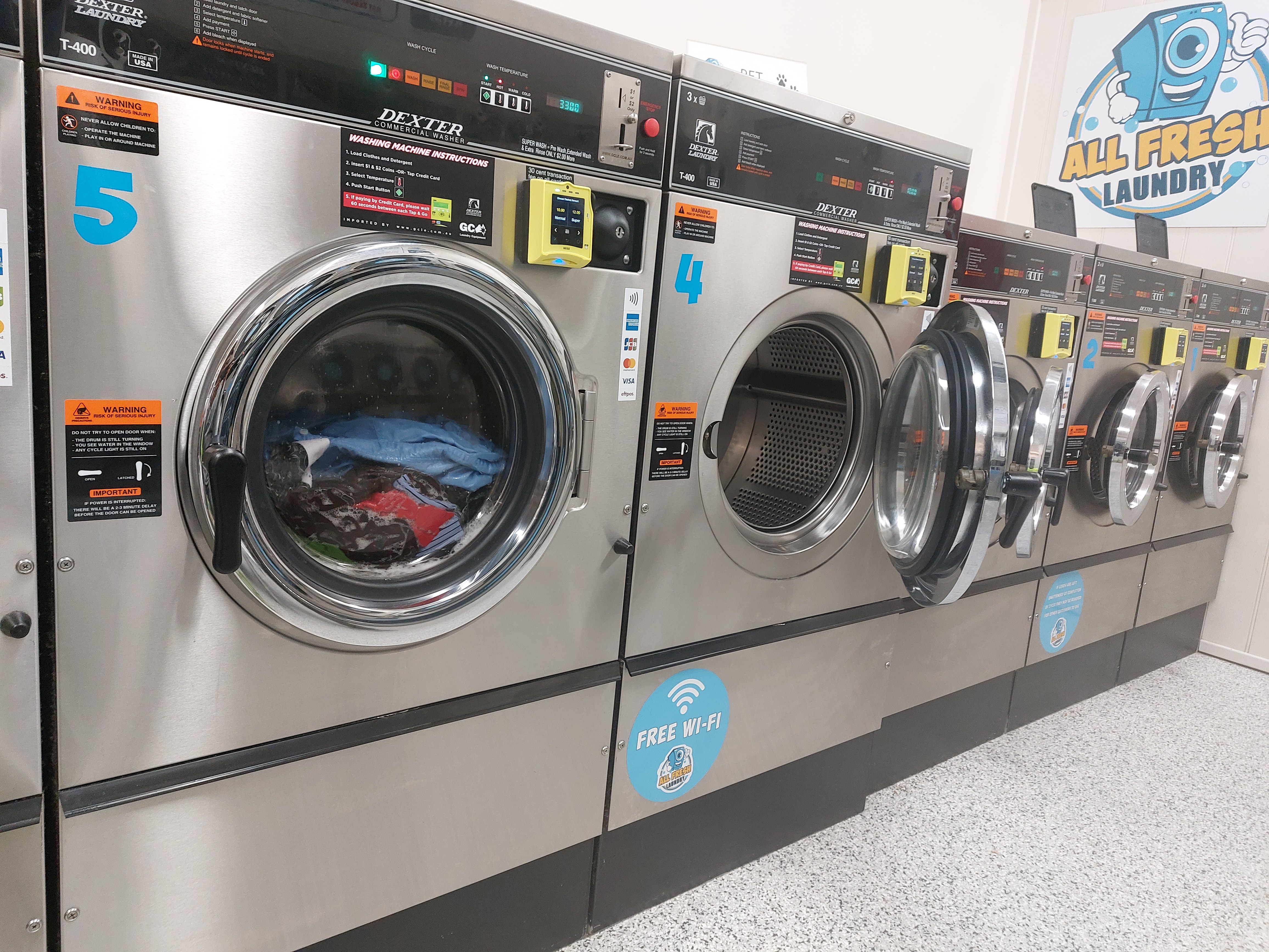 Rows of modern laundry machines in a laundromat
